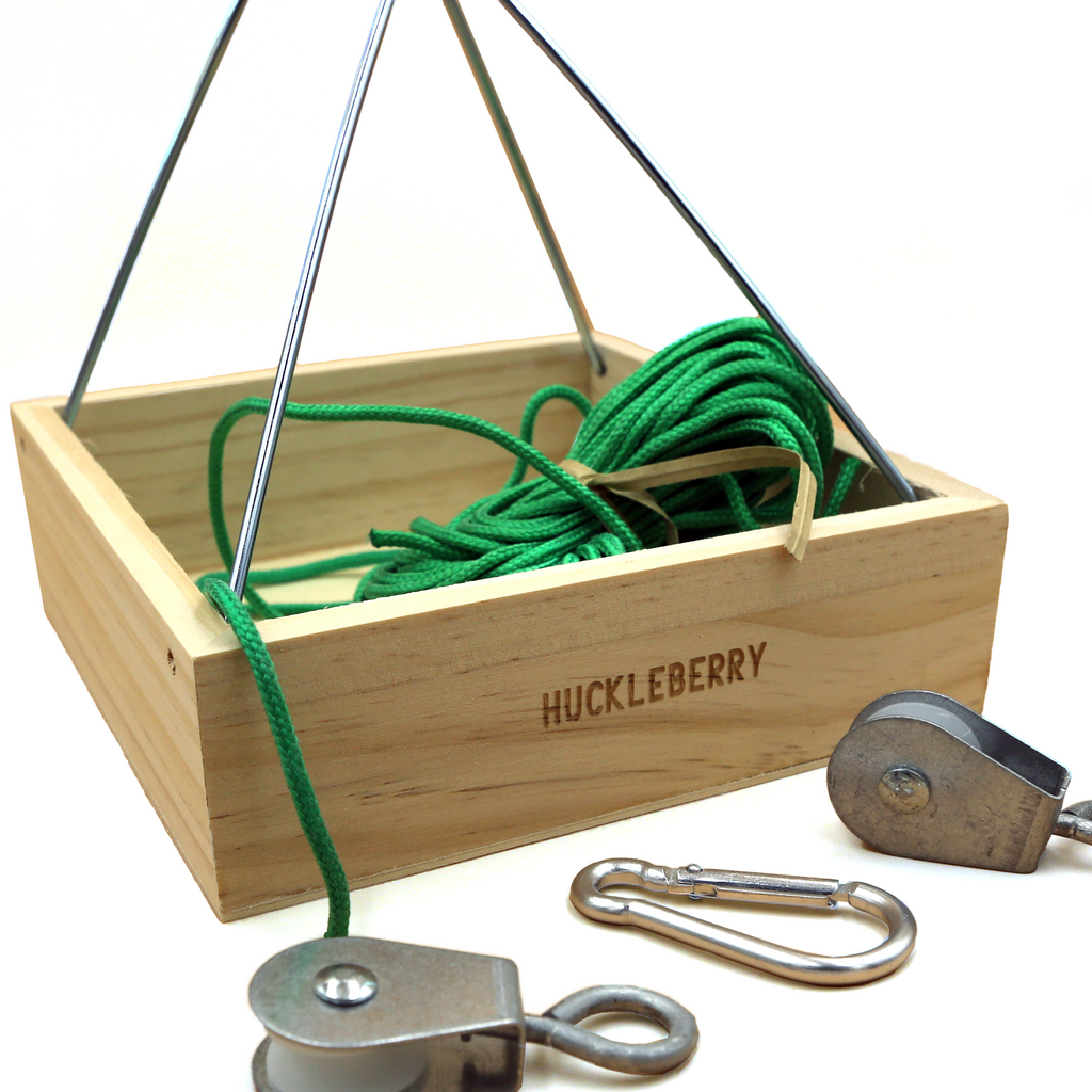 Wooden box with pulleys and green rope